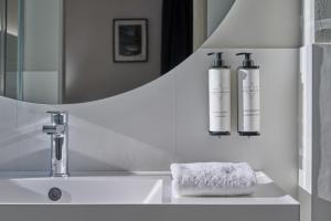 a bathroom with a sink and a mirror at RMH Modena Raffaello in Modena
