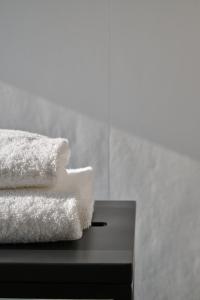 a pile of towels sitting on top of a table at RMH Modena Raffaello in Modena