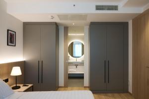 a bedroom with a bed and a bathroom with a sink at RMH Modena Raffaello in Modena