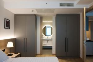 a bedroom with a bed and a bathroom with a sink at RMH Modena Raffaello in Modena