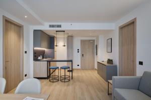 a kitchen and living room with a table and chairs at RMH Modena Raffaello in Modena