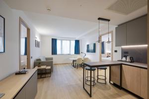 a living room with a kitchen and a dining room at RMH Modena Raffaello in Modena