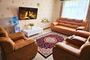 a living room with two couches and a fireplace at Havan Furnished Apartment-Milimani N9 in Nakuru
