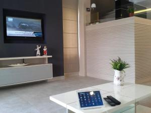 a living room with a tablet on a white table at Lighthouse Lydia Villas in Fethiye