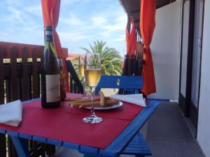 stół z lampką wina i butelką w obiekcie Casa Vacanze Bungalow I Girasoli w mieście Ventimiglia