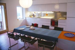 a kitchen with a blue table and chairs in it at Logenplatz über Trier in Trier