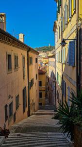 an empty alley in an old city with buildings at Roof10 in Ancona