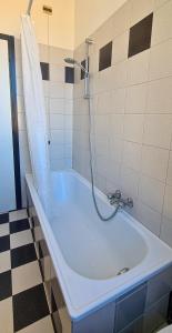 a bath tub with a shower in a bathroom at Roof10 in Ancona +14 photos