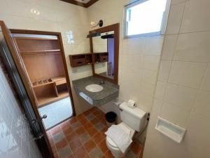 a small bathroom with a toilet and a sink at Talya Patong Hotel in Patong Beach