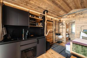 a kitchen and living room in a tiny house at Brandlalm Tinys in Gundisch +10 photos