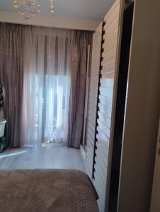 a bedroom with a bed and a window with curtains at تركيا 