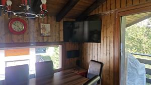 une salle à manger avec une table et une horloge murale dans l'établissement La Remointze, à Veysonnaz