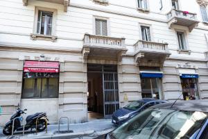 a motorcycle parked in front of a building at Salmini Porta Romana Apartment in Milan