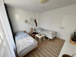 a bedroom with two beds and a table and mirrors at KnocksCasa4you 2 Zimmer Monteure Appartement Nr 21 in Marburg in Marburg an der Lahn
