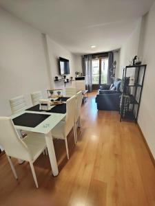 a dining room and living room with a table and chairs at Ático Duplex CALLE MAYOR in El Burgo de Osma