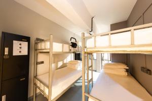 a room with two bunk beds in a building at D'Nova Hotel Kallang in Singapore