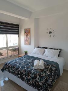 a bedroom with a bed with two towels on it at Margarita & More, Ocean in Porlamar +39 photos