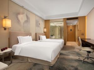A bed or beds in a room at Yun Hotel Wuhan