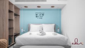 a bed with a teddy bear sitting on top of it at דירה מעוצבת עם נוף מטריף לים במתחם סי סייד - Edomlux in Eilat