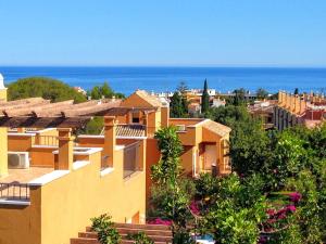 un grupo de edificios con el océano en el fondo en Villas Altos De Marbella, en Marbella