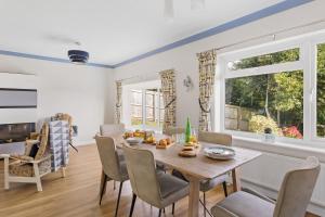 a dining room with a table and chairs at The Old Orchard in Dartmouth