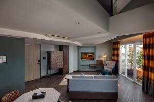a living room with a couch and a table at The George Penang by The Crest Collection in George Town