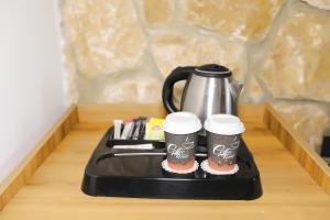 a tray with two coffee cups and a tea kettle at Dedeman Van Resort & Aquapark in Van