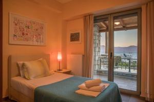 a bedroom with a bed and a window with a view at Villa Leon in Chalkida