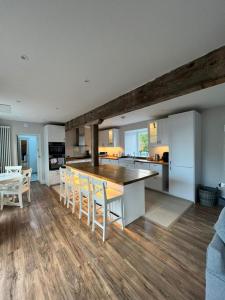a kitchen and dining room with a table and chairs at The Carthouse (Luxury 2 bed with private hot tub) in Newburgh