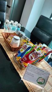 a table with food and bottles of water on it at ZDQ Homestay in Kampong Padang Keladi