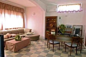 a living room with a couch and a piano at Residence Hotel La Commenda in Montefiascone