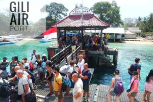 a group of people standing on a dock in the water at Gili Ferries Manta Express in Padangbai