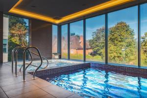 a swimming pool in a house with windows at Harbour Hotel Guildford in Guildford