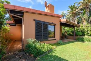 a house with a window and a yard at San Lameer Villa 3314 - 2 Bedroom Superior - 4 pax - San Lameer Rental Agency in Southbroom