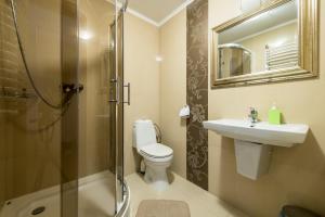 a bathroom with a toilet and a sink and a shower at Hotel Pałac Akropol in Lublin