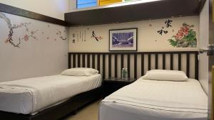 Postel nebo postele na pokoji v ubytování GOPENG INN