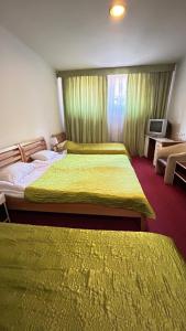 a hotel room with two beds and a television at Motel Tiron in Kakanj +33 photos