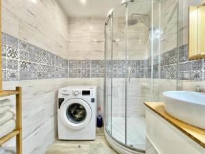 a bathroom with a washing machine and a shower at Family-Friendly Home in Bratislava in Bratislava