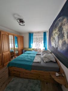 a bedroom with a bed with a large painting on the wall at Direkt im Stadt-Zentrum, beim Metzger einchecken! in Mülheim-Kärlich