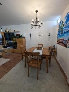 a dining room with a wooden table and chairs at Direkt im Stadt-Zentrum, beim Metzger einchecken! in Mülheim-Kärlich