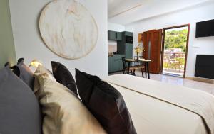 a bedroom with a bed with pillows at Small stone house in a quiet place island Solta in Stomorska