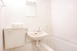 a white bathroom with a sink and a mirror at Hotel Hanabi - Vacation STAY 62608v in Tokyo