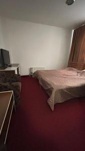 a bedroom with a bed and a television in it at Motel Tiron in Kakanj