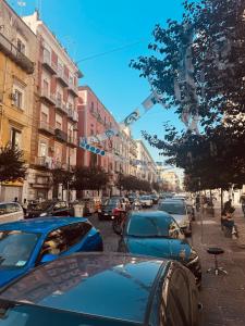 a busy city street with cars parked on the street at Cuore Di Napoli in Naples