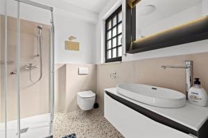 a bathroom with a sink and a toilet and a shower at Charming apartment Emilija in Pula