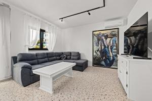 a living room with a couch and a tv at Charming apartment Emilija in Pula