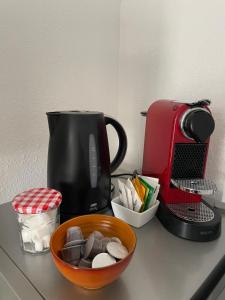 a counter topped with a coffee maker and a bowl of cookies at Le Mustang Internet Fibre Netflix in Joigny