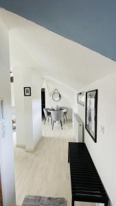 a white living room with a dining room table at K-Business-Apartments in Oberesslingen