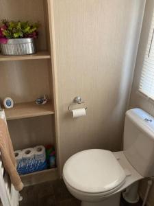 a small bathroom with a white toilet in a room at The fairways in Lincoln