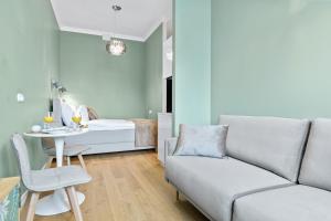 a living room with a couch and a table at Tempus Te Premium Duo Lofts Tartu - private cinema, gym and terrace in Tartu